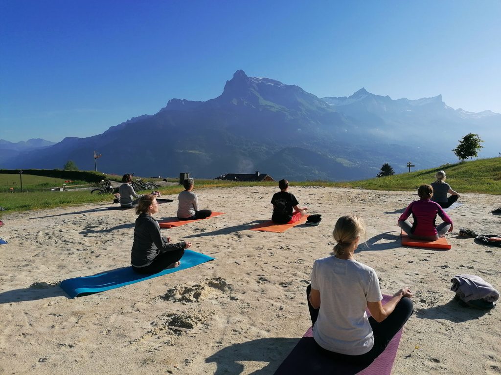 outdoor yogists facing the fiz during well-being summits