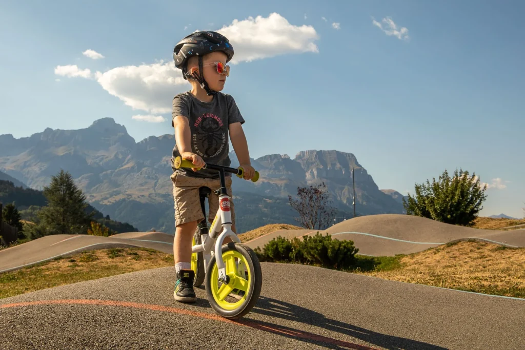 young child cycling on pumptrack combloux view aravis