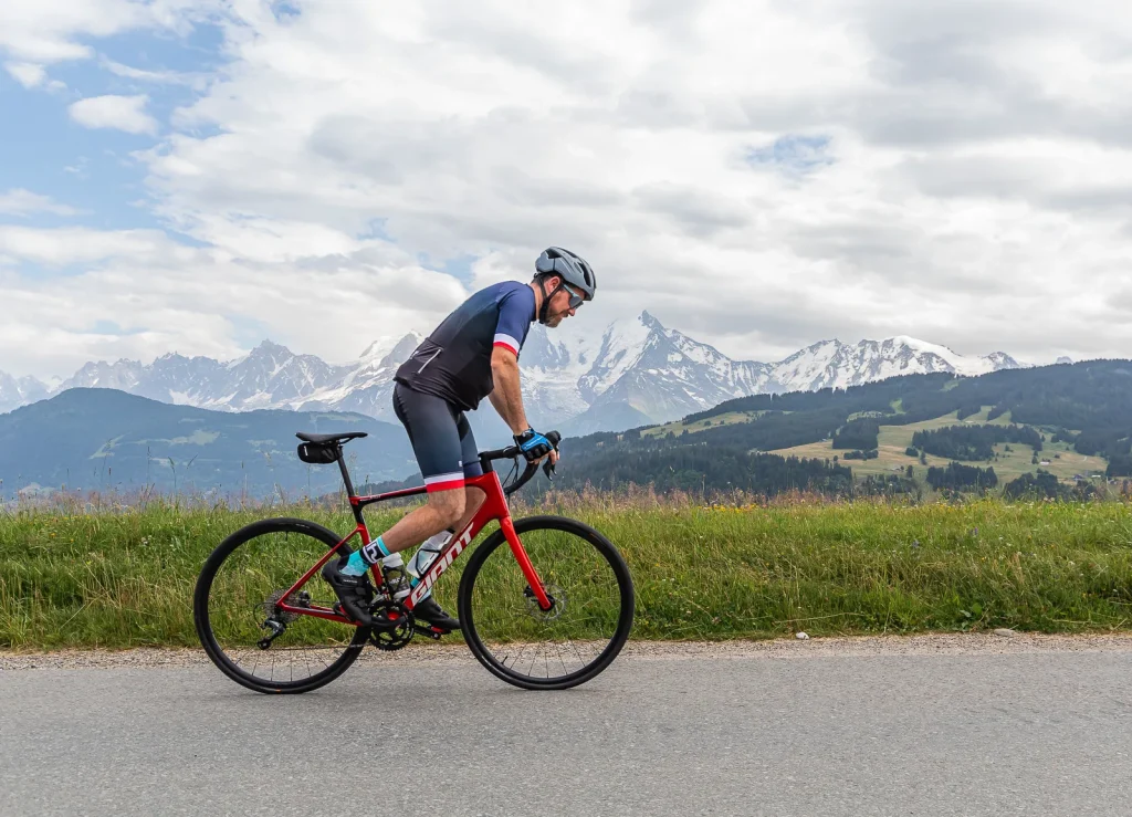 cyclist pedaling on a balcony facing mont blanc -