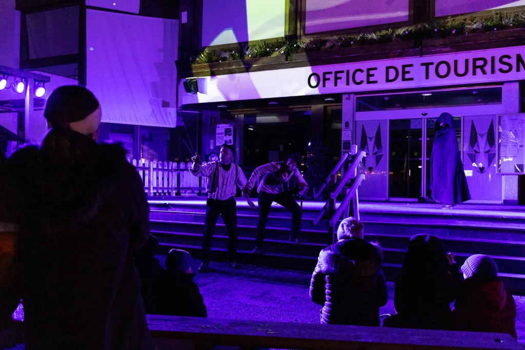 comedian legend combloux in front of the tourist office purple lighting in the middle of the night