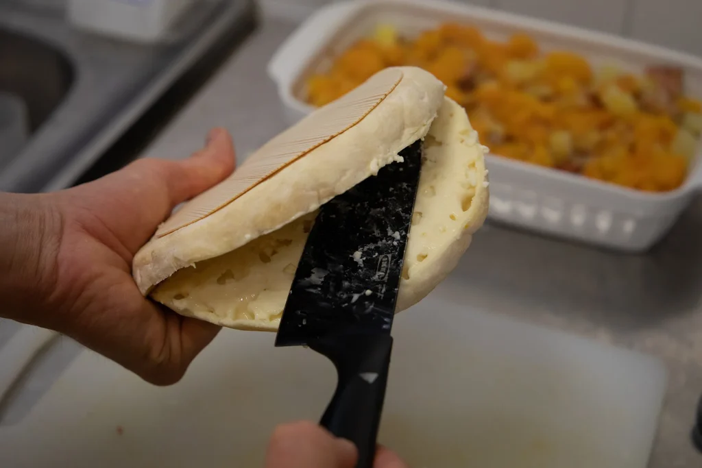 Cutting the reblochon for the tartiflette