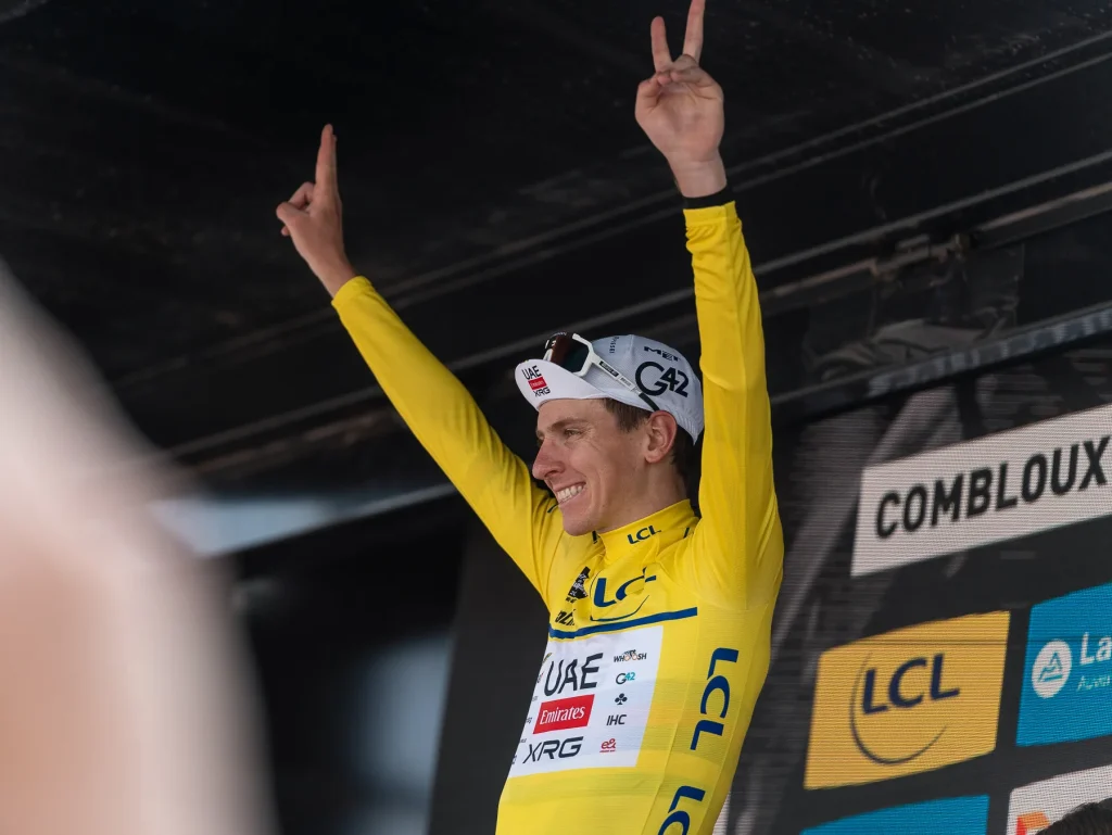 Tadej Pogačar takes the yellow jersey on the podium of the sixth stage of the Critérium du Dauphiné in Combloux on June 13, 2025.
