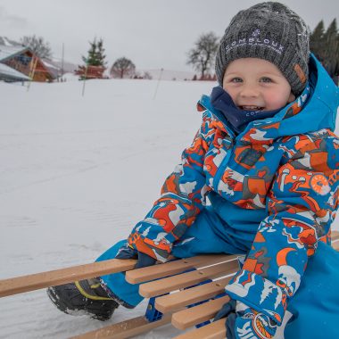 Niño en un trineo en Combloux