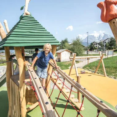 wide shot child playing structure games louparc combloux