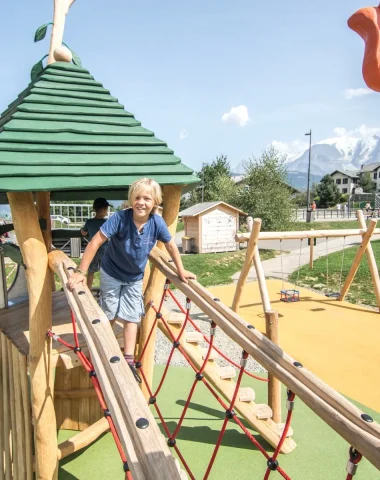 wide shot child playing structure games louparc combloux