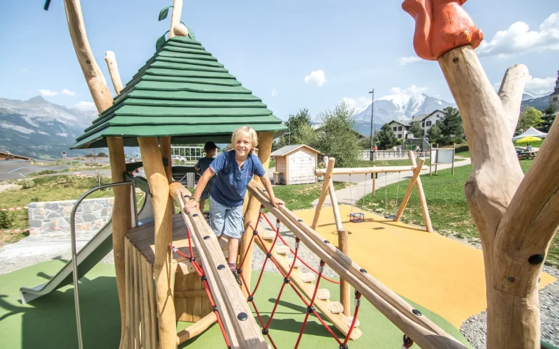 wide shot child playing structure games louparc combloux