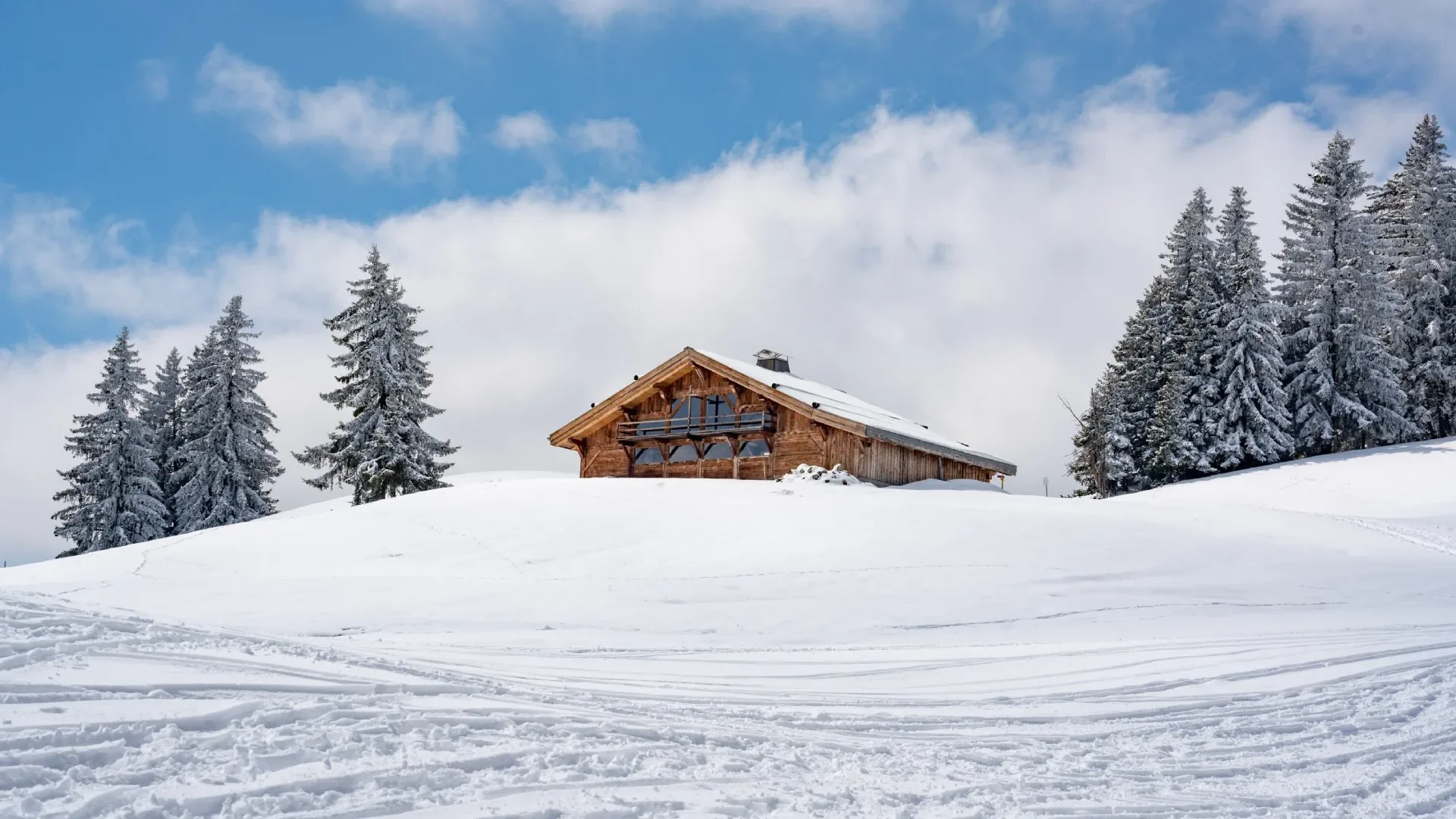 chalet mountain pasture snowy landscape blue sky ski resort Combloux