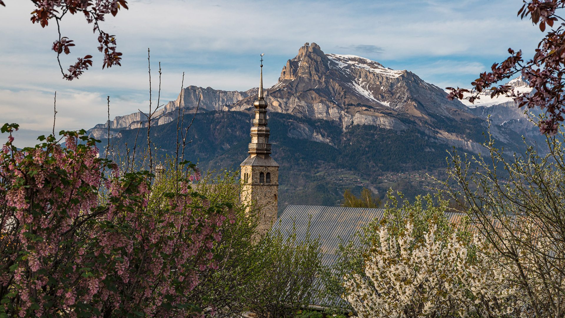 Bell tower of the Church of Combloux in spring