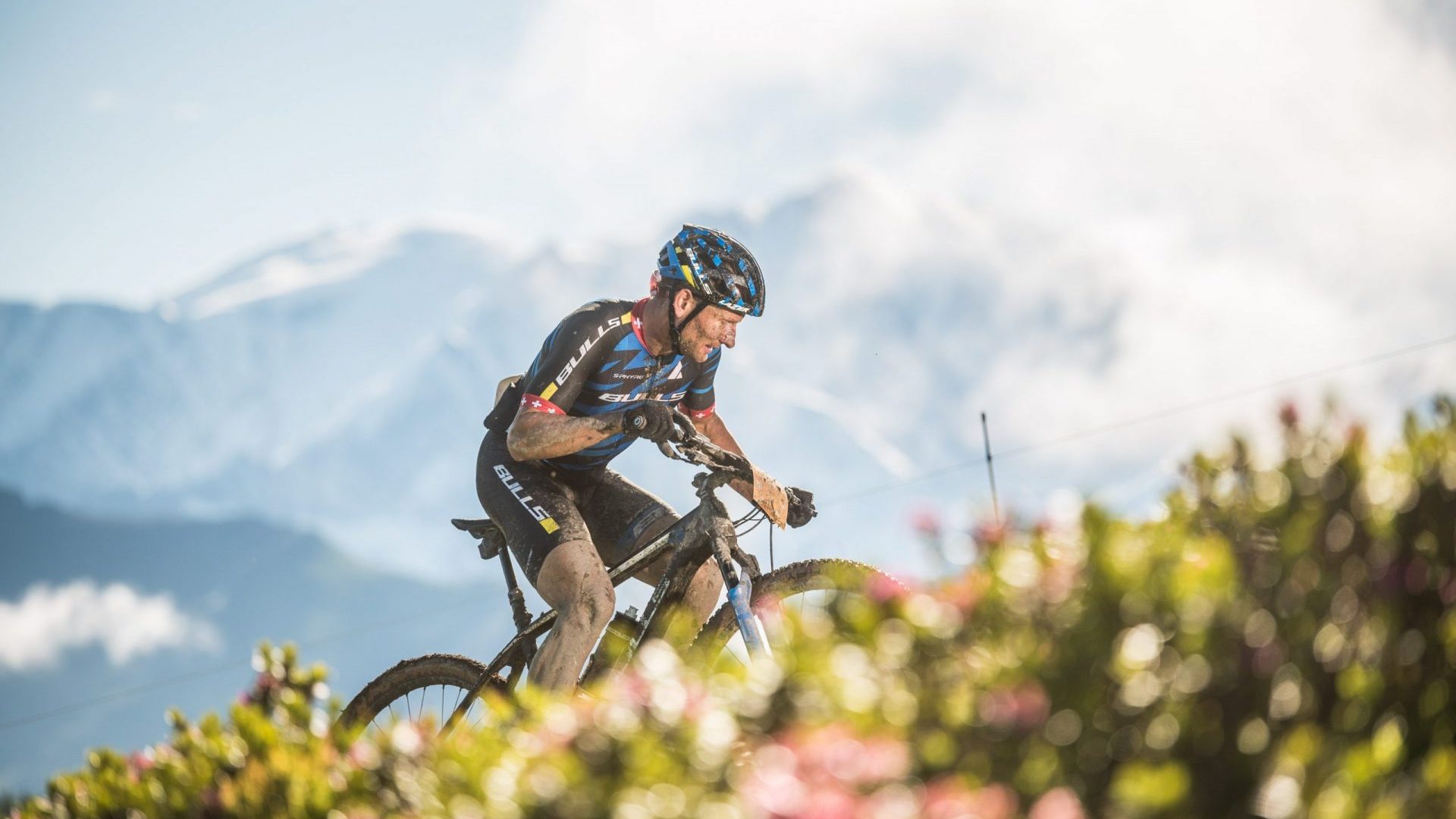 mountain biker on the alpine trail facing Mont Blanc