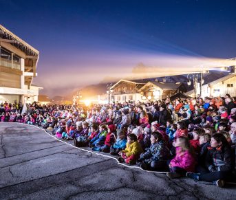 lit crowd in front of scene legende combloux forecourt tourist office combloux